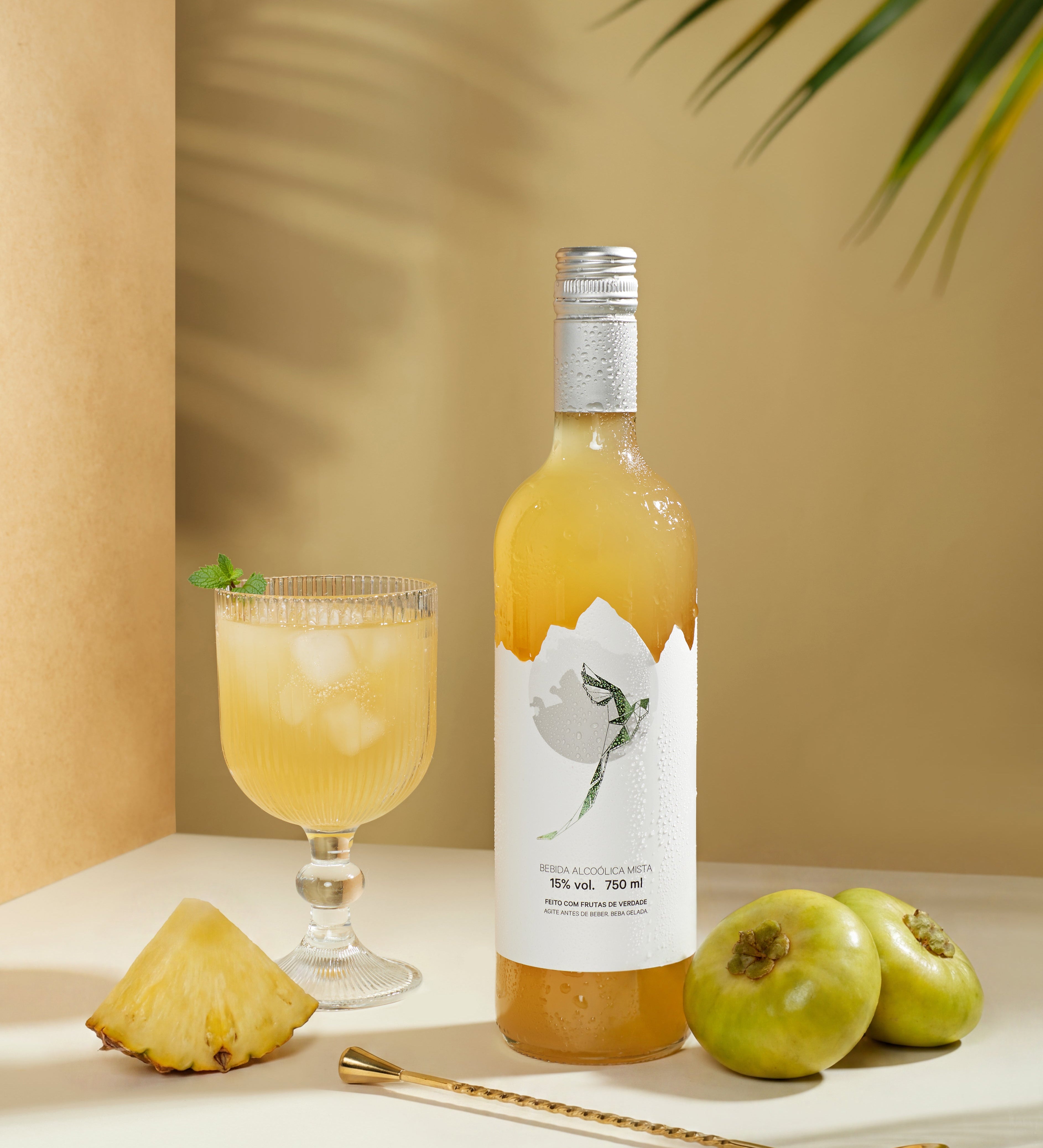 Quetzalli Cambuci e Abacaxi garrafa de 750 ml com frutas in natura de cambuci e abacaxi com uma taça de vinho com gelo 